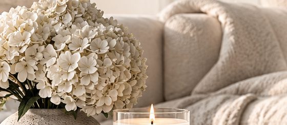 Sofa with hydrangeas and a lit candle
